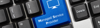 Keyboard di un pc a cui è stato aggiunto un tasto blu con la scritta MANAGED SERVICE PROVIDER.